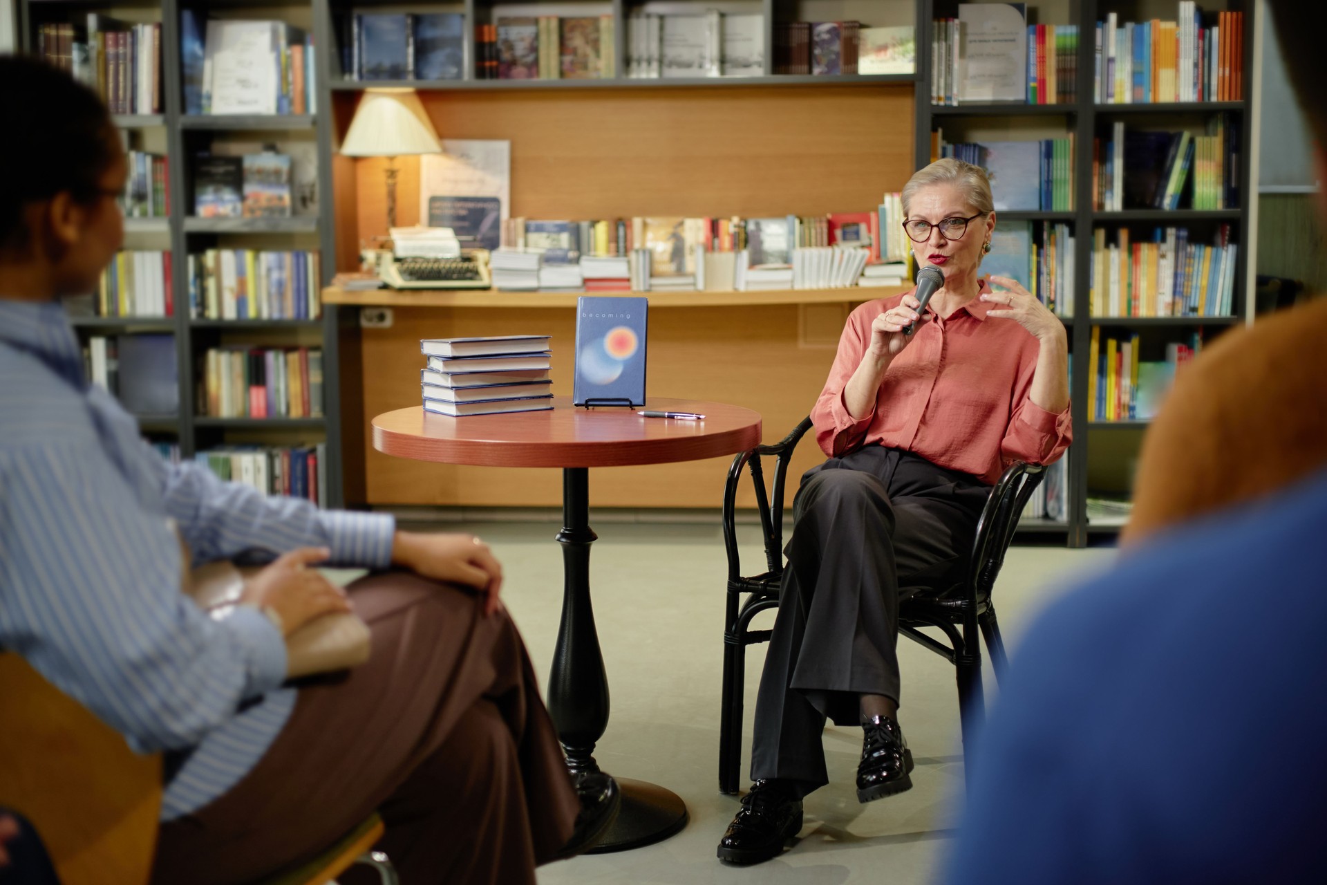 Senior Caucasian Woman Speaking during Session with Audience in Bookstore